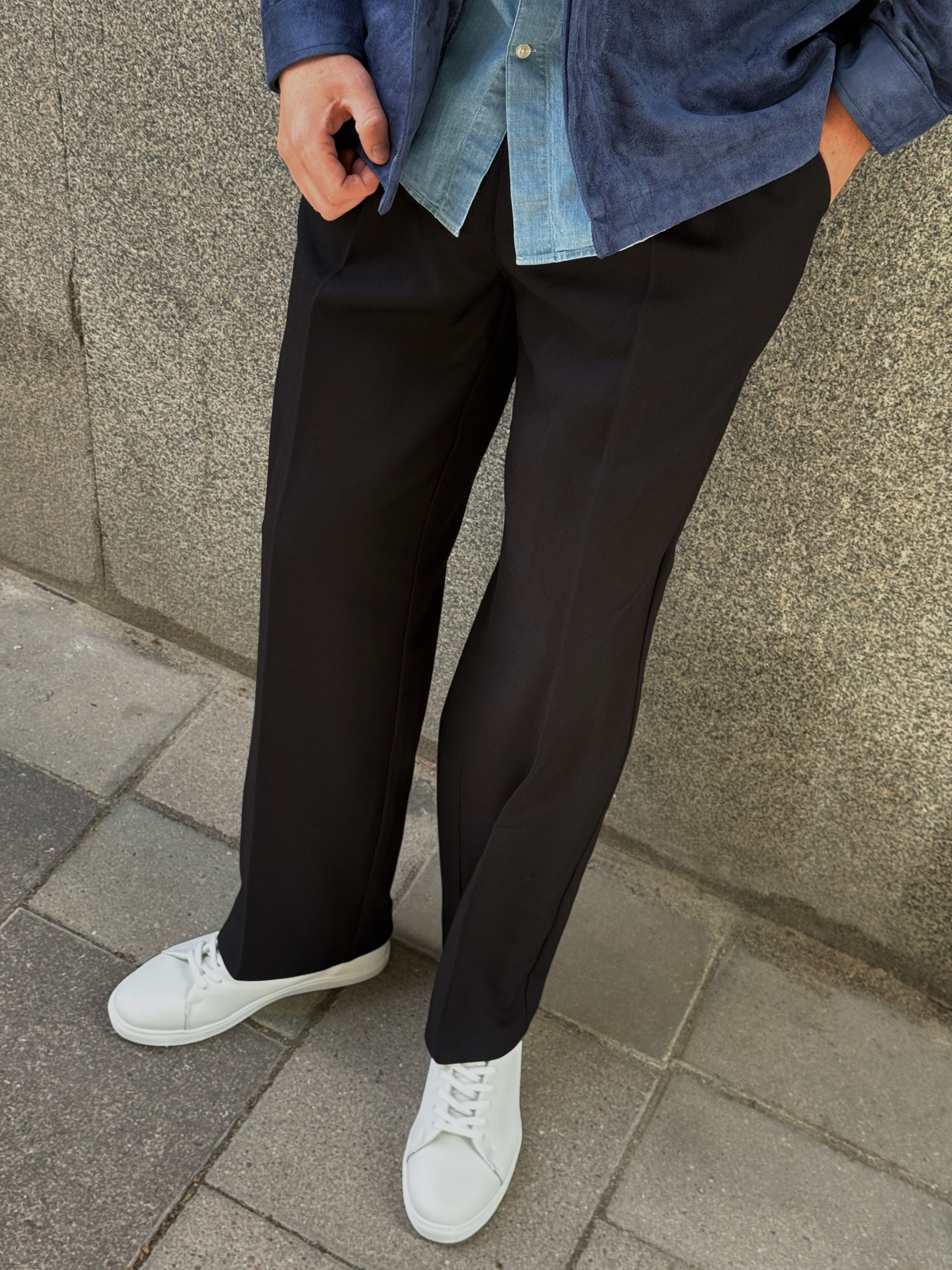 Denim overshirt, black tailored trousers and white sneakers, detail